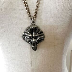 Silver tone face pendant necklace